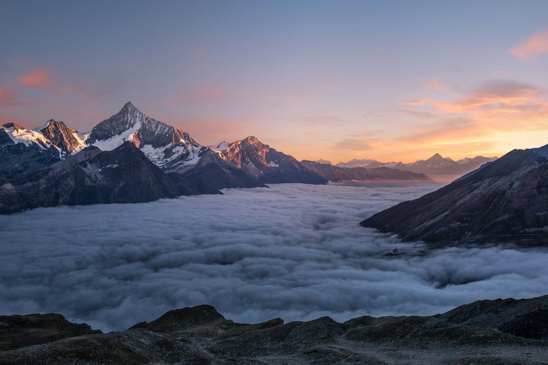 Above the clouds at golden sunrise